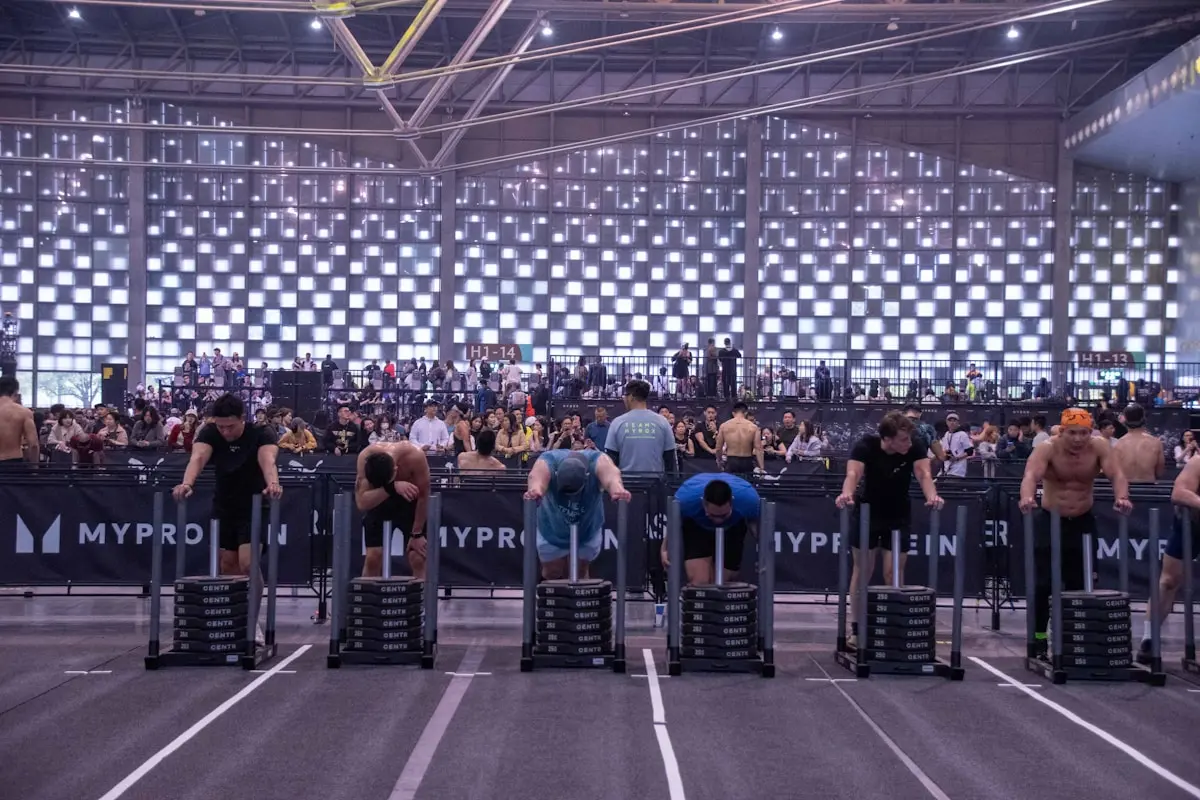 Athletes pushing sleds during a Hyrox event